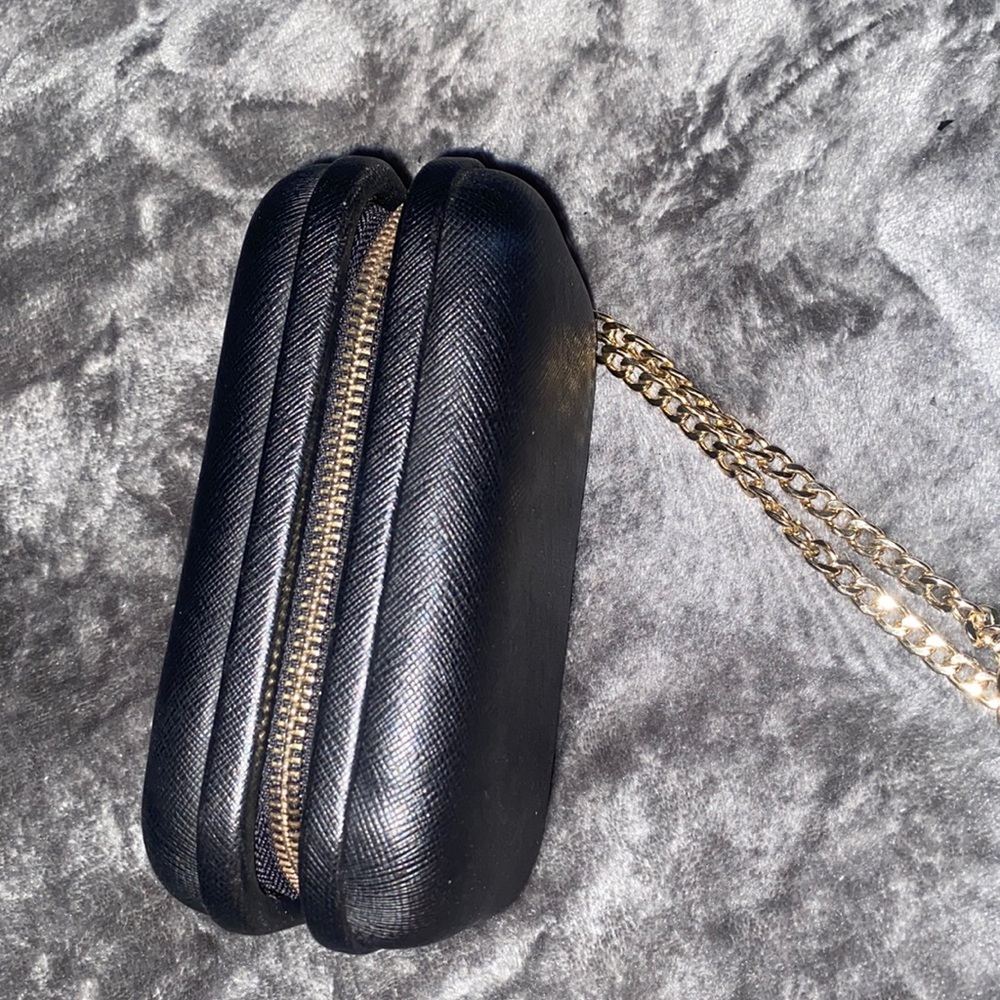 Black wristlet with gold chain.